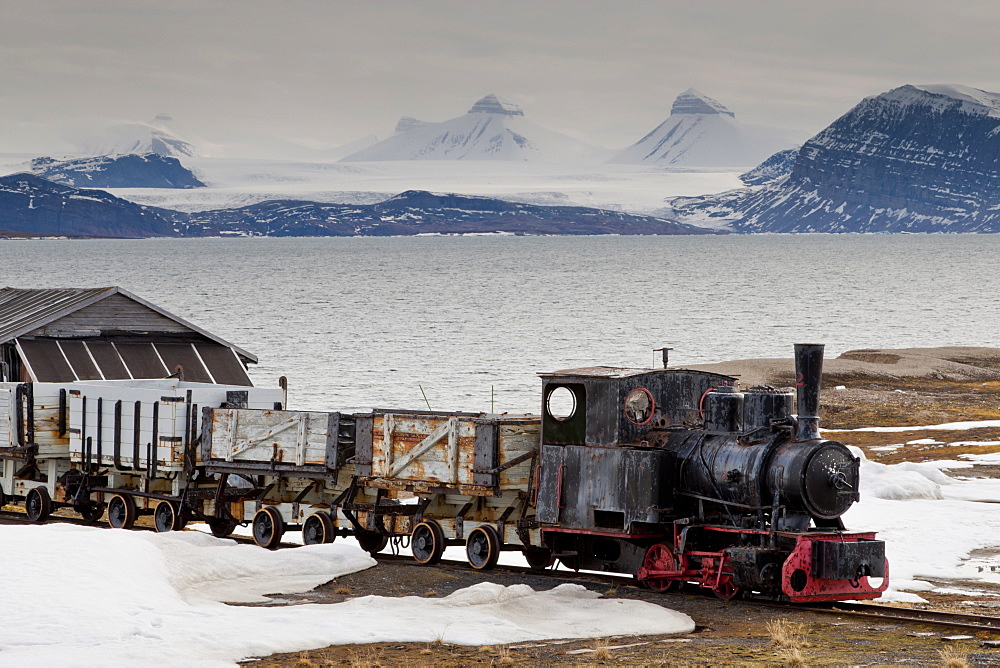 Old coal train with snow, fjord and mountains, Ny Alesund, Spitsbergen (Svalbard), Arctic, Norway, Scandinavia, Europe 