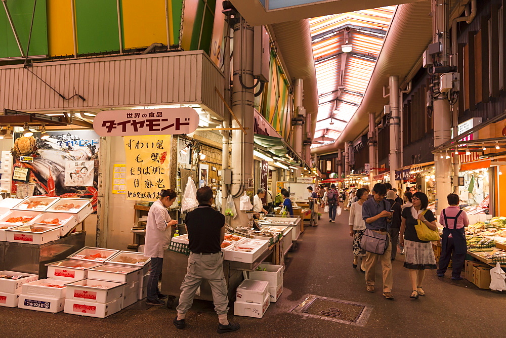 Shoppers at Omicho fresh food market, busy and colourful network of covered streets lined by stalls, Kanazawa, Japan, Asia