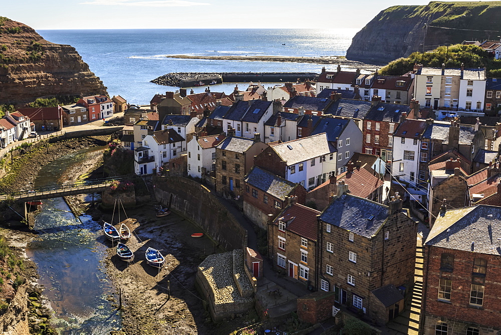 Winding alleys, fishing boats and sea, elevated view of village in summer, Staithes, North Yorkshire Moors National Park, Yorkshire, England, United Kingdom, Europe