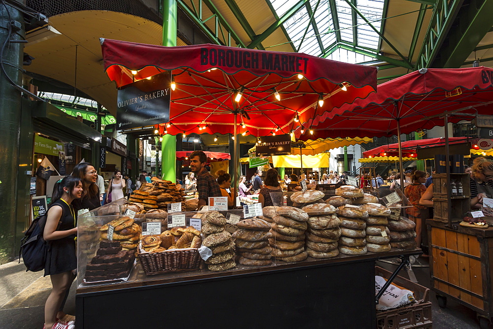 Customers at a bread stall, Borough Market, Britain's most renowned food market, Southwark, London, England, United Kingdom, Europe