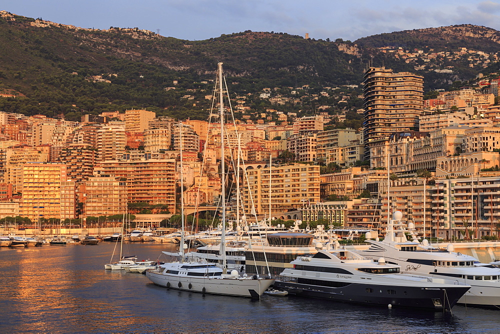 Yachts in the glamorous Port of Monaco (Port Hercules) at sunrise, from the sea, Monte Carlo, Monaco, Mediterranean, Europe