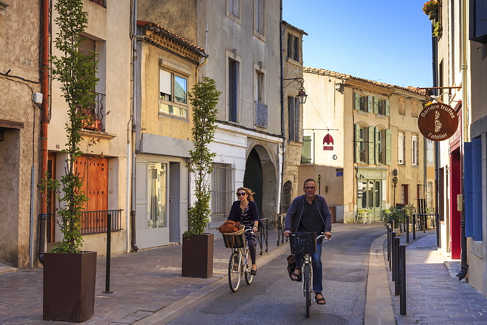 Cyclists in a Ville Basse narrow street, Carcassonne, Languedoc-Roussillon, France, Europe