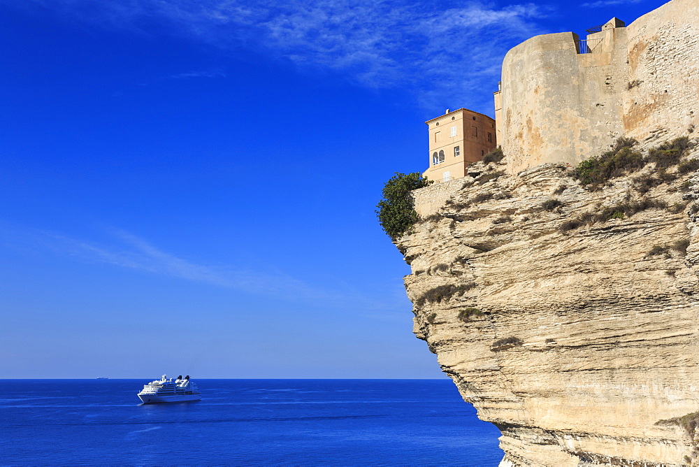 Old citadel atop cliffs with cruise ship anchored off shore, Bonifacio, Corsica, France, Mediterranean, Europe