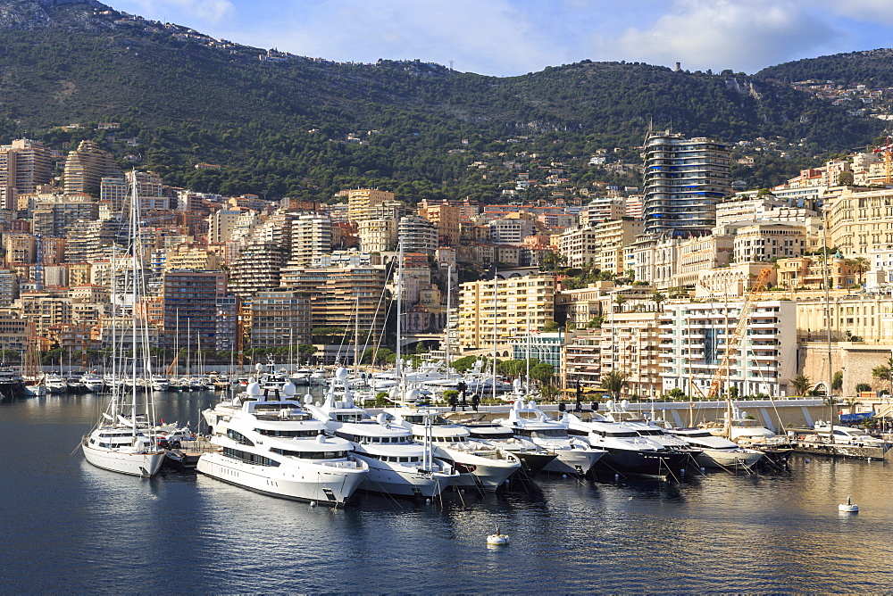 Pastel hues of the glamorous harbour of Monaco (Port Hercules) with many yachts, view from the sea, Monte Carlo, Monaco, Cote d'Azur, Mediterranean, Europe