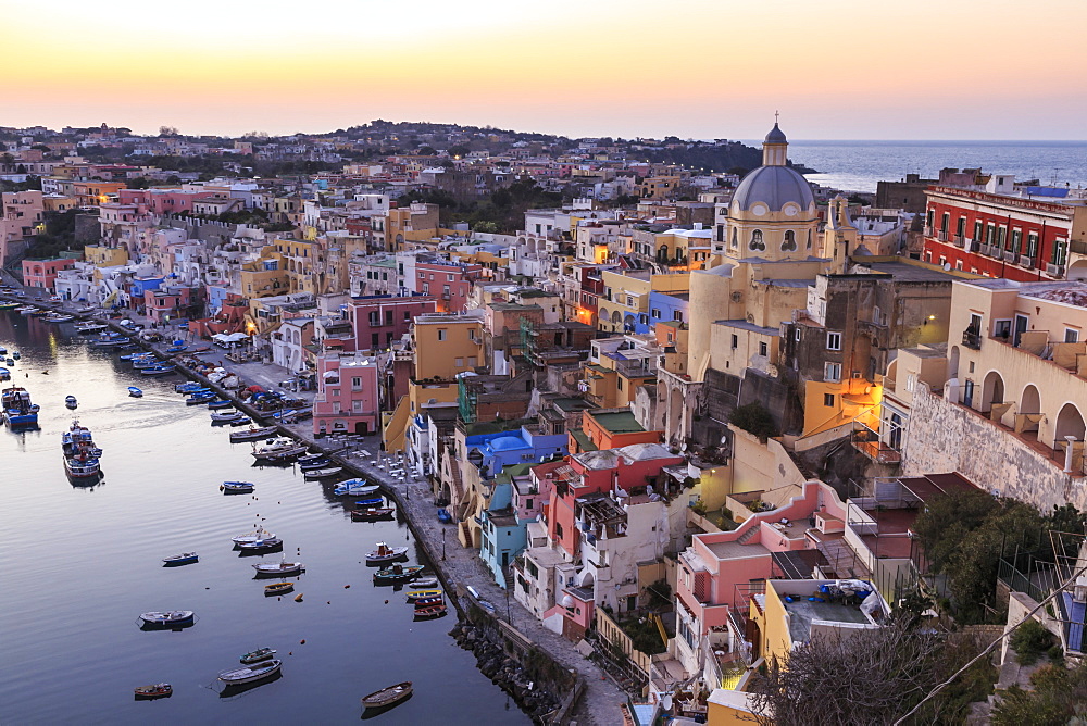 Marina Corricella, blue hour after sunset, fishing village, colourful houses, boats and church, Procida, Bay of Naples, Campania, Italy, Europe