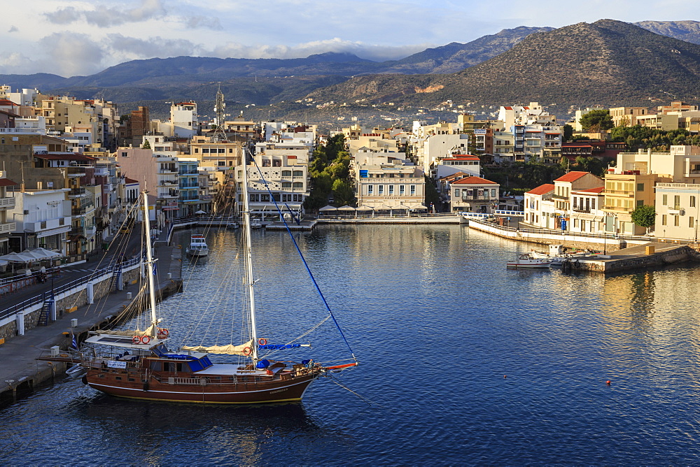 Attractive harbour and town backed by mountains, from Mirabello Bay, Agios Nikolaos, Lasithi, Crete, Greek Islands, Greece, Europe