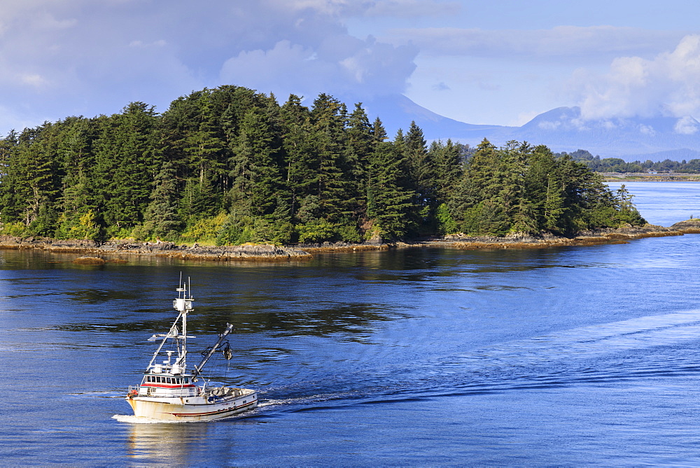 Commercial fishing boat and small forested island, rare summer sun, Sitka Sound, Sitka, Baranof Island, Southeast Alaska, United States of America, North America