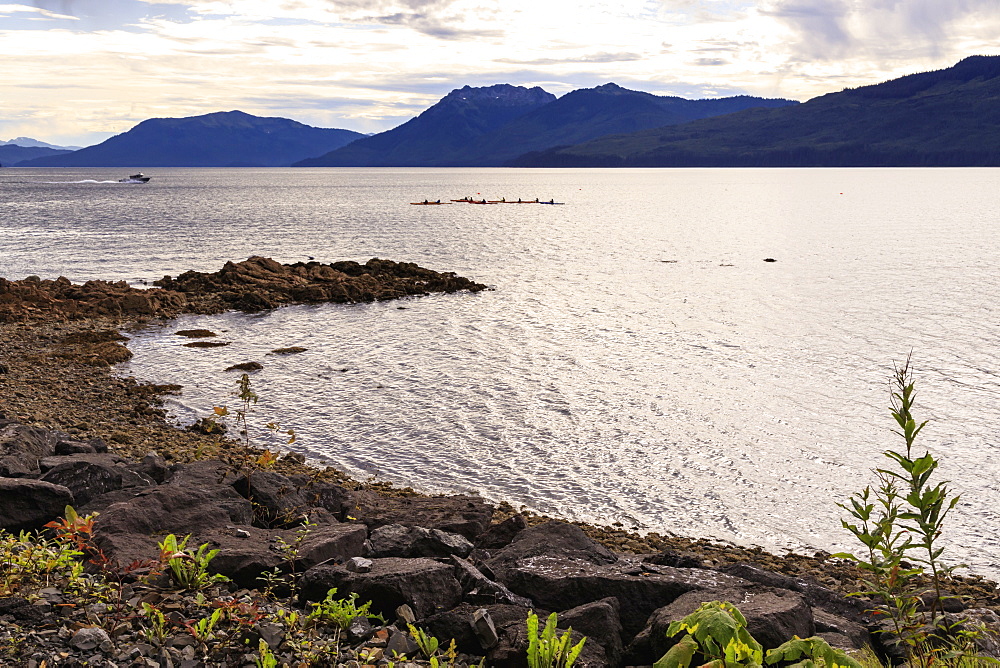 Icy Strait Point, near Hoonah, shore and kayaks, distant mountains, summer, Chichagof Island, Inside Passage, Alaska, United States of America, North America