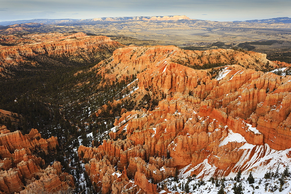 Hoodoos, trees and distant view with snow on a cloudy late winter afternoon, Bryce Point, Bryce Canyon National Park, Utah, United States of America, North America