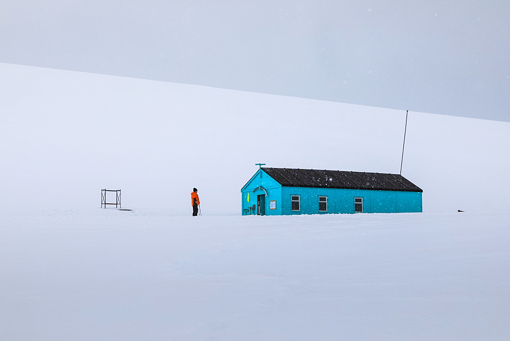 Damoy Hut, expedition ship visitor in the snow, Historic Monument, Dorian Bay, Wiencke Island, Antarctic Peninsula, Antarctica, Polar Regions