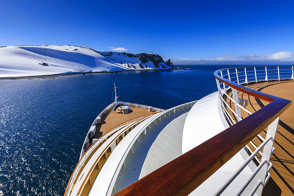 Cruise ship deck with couple in hot tub, off Half Moon Island, blue sky and evening sun, South Shetland Islands, Antarctica, Polar Regions