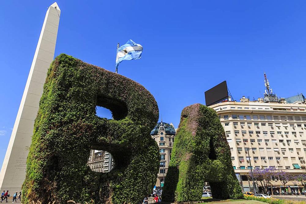 BA in topiary, Obelisco iconic monument and flag, Plaza de la Republica, Congreso and Tribunales, Buenos Aires, Argentina, South America