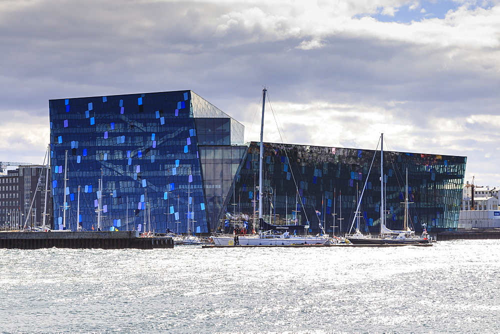 Harpa Conference and Concert Hall and yachts, from Thufa, green mound in summer, Reykjavik, Iceland, Polar Regions