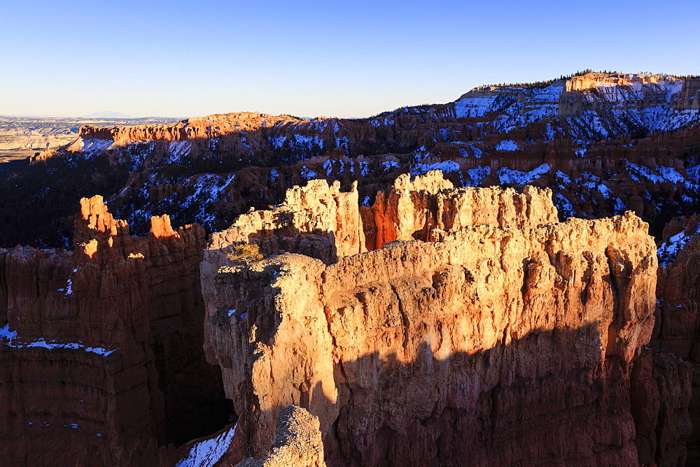 Rocks lit by late afternoon sun with snow, from Sunset Point, Bryce Canyon National Park, Utah, United States of America, North America