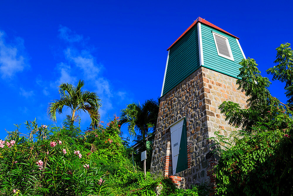 Swedish Bell Tower, palm trees and flowering shrubs, Gustavia, St. Barthelemy (St. Barts) (St. Barth), West Indies, Caribbean, Central America