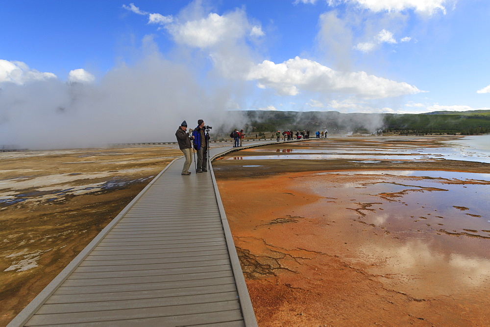 Tourist taking a photograph of Grand Prismatic Spring, Midway Geyser Basin, Yellowstone National Park, UNESCO World Heritage Site, Wyoming, United States of America, North America