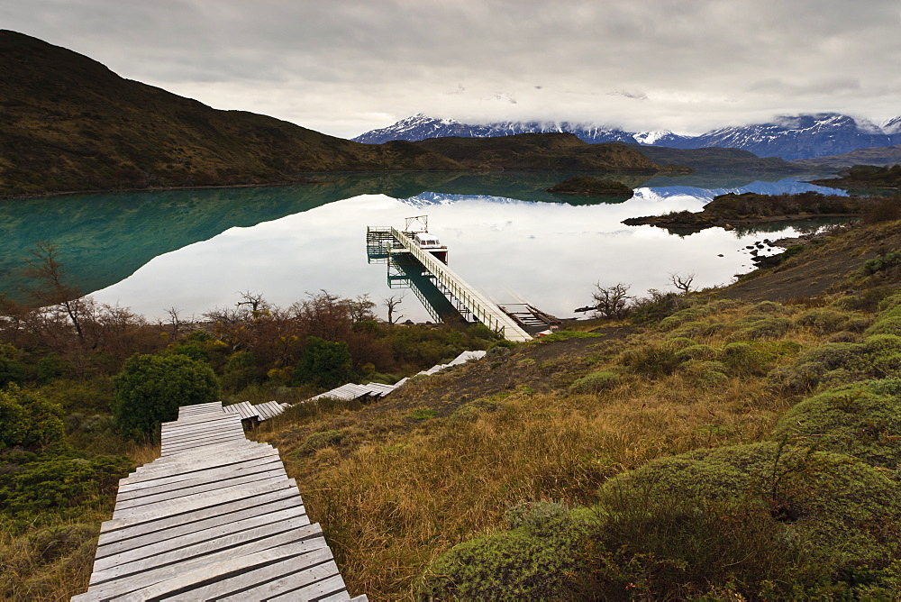 Steps to boatdock and reflections in Lago Pehoe, Torres del Paine National Park, Patagonia, Chile, South America 