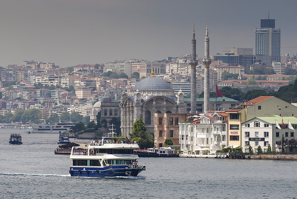 Ortakoy Mecidiye Mosque and passenger ferry, Ortakoy, from Bosphorus Strait with Istanbul city skyline behind, Istanbul, Turkey, Europe