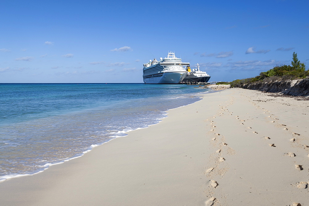 Footprints on a white sand beach with two cruise ships docked in a turquoise sea, Grand Turk, Turks and Caicos, West Indies, Caribbean, Central America