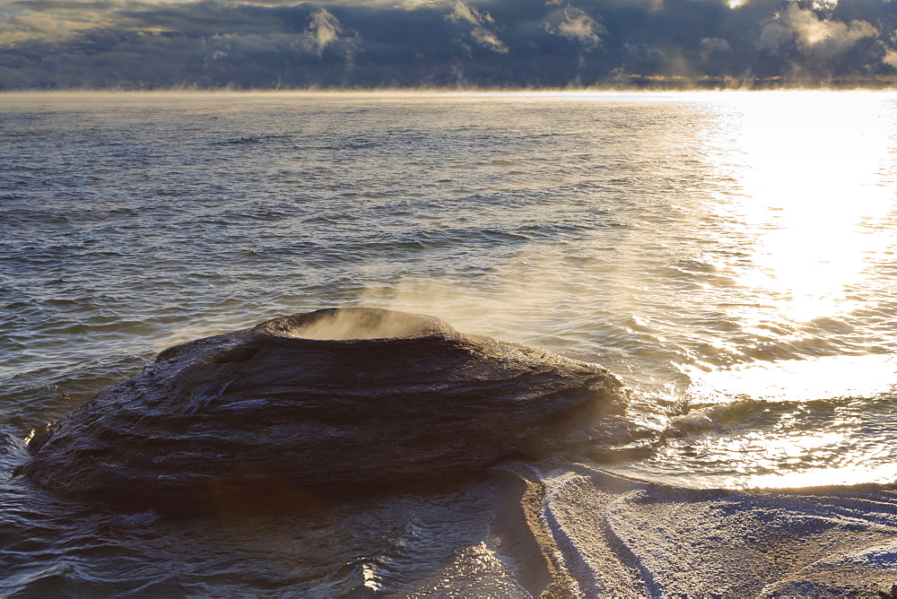 Fishing Cone Geyser with freezing mists, Yellowstone Lake at West Thumb Geyser Basin, Yellowstone National Park, UNESCO World Heritage Site, Wyoming, United States of America, North America 