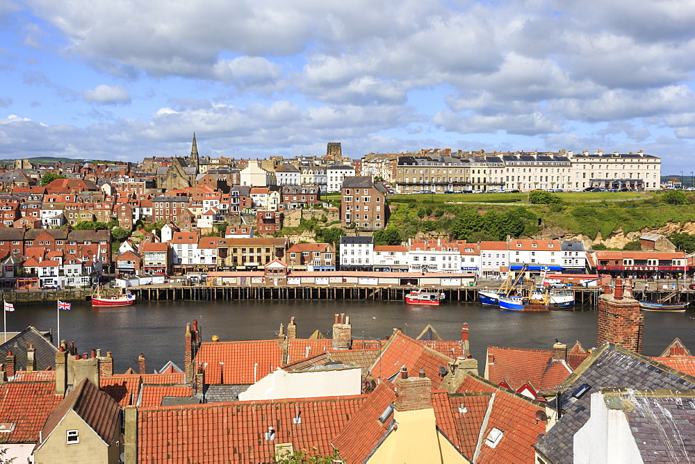 View across rooftops to West Side town, boats, pier, fish market and elegant hotels, Whitby, North Yorkshire, England, United Kingdom, Europe