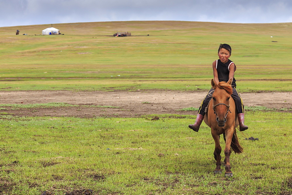 Horse and boy riding bareback with ger behind at summer nomad camp, Khujirt, Uvurkhangai (Ovorkhangai), Central Mongolia, Central Asia, Asia