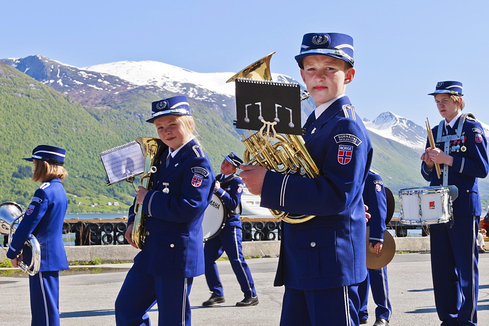 Fjordside youth brass band in a contest, snow capped mountains behind, Andalsnes, Romsdalsfjord, Norway, Scandinavia, Europe