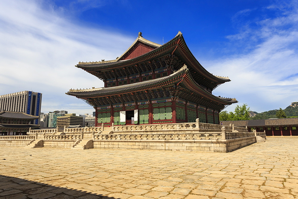 Imperial Throne Hall (Geunjeongjeon) with modern city skyline , Gyeongbokgung Palace, Seoul, South Korea, Asia