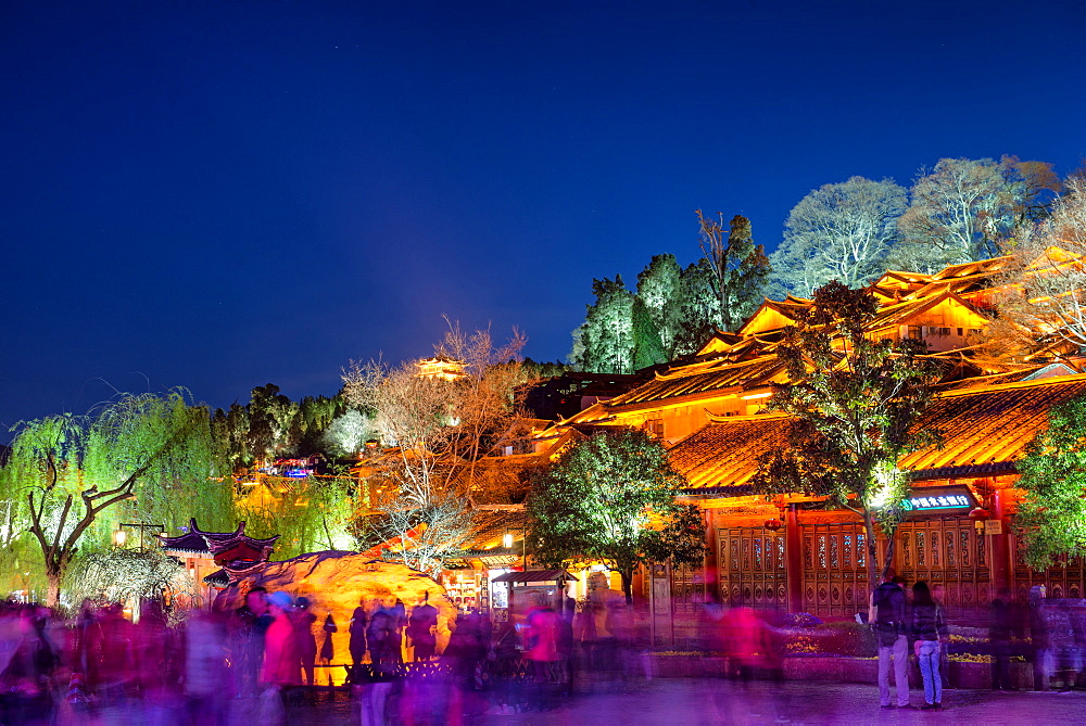 Colourfully illuminated traditional architecture and trees in the old town of Lijiang, UNESCO World Heritage Site, Yunnan province, China, Asia 