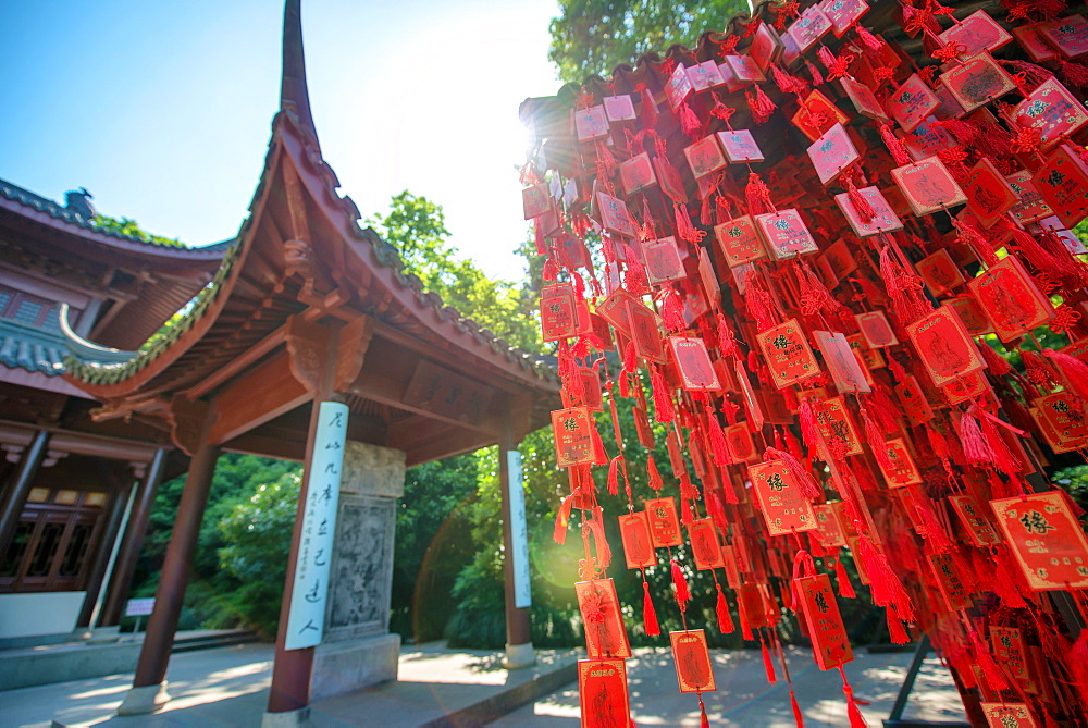 Red wooden traditional Chinese good luck charms and pagoda in background, Hangzhou, Zhejiang, China, Asia