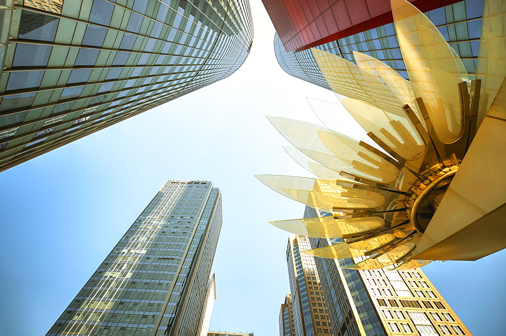 Glass and golden metal Lotus installation in front of HSBC Bank with surrounding new skyscrapers in Jianggan district, Hangzhou, Zhejiang, China, Asia