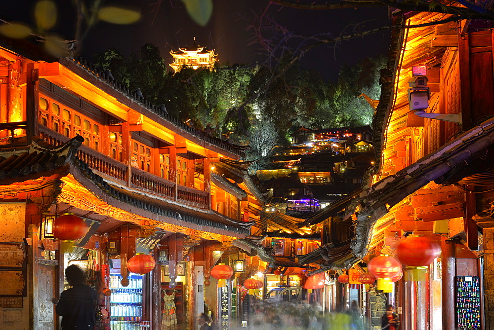 Busy Lijiang Old Town, UNESCO World Heritage Site, at night with Lion Hill and Wan Gu Tower, Lijiang, Yunnan, China, Asia 