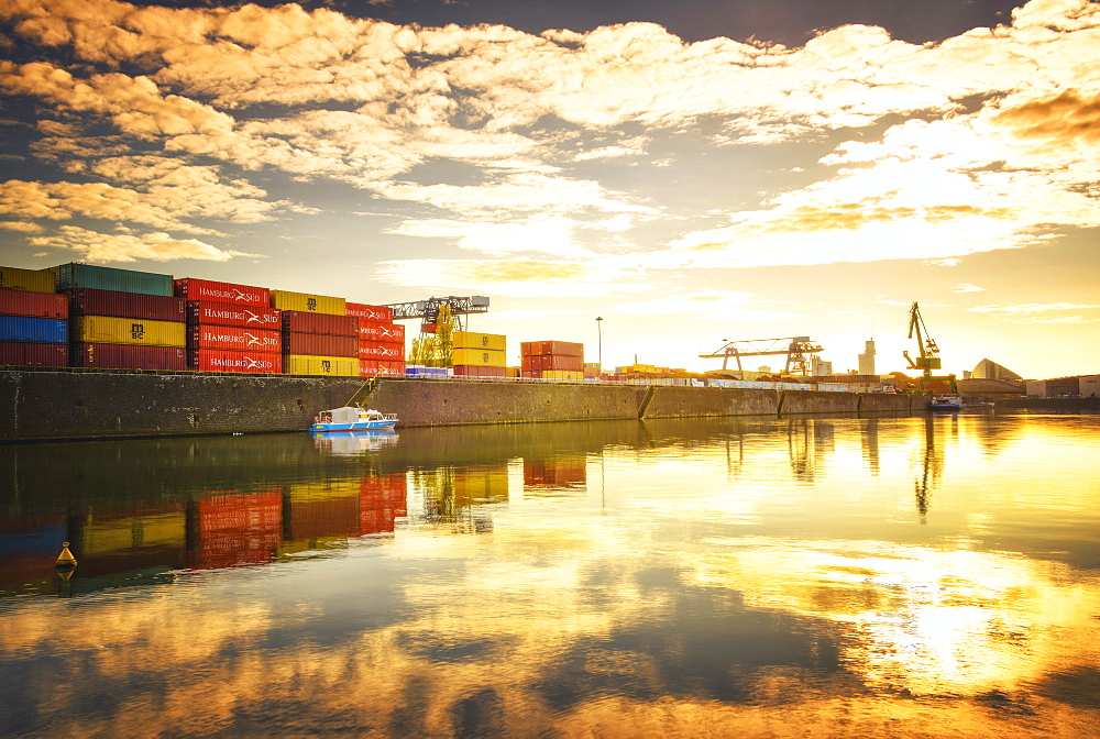 One of Main River's side channels with stacked containers and golden reflections in an industrial setting, Frankfurt, Hesse, Germany, Europe