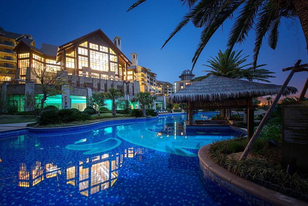 Exterior view of Hilton Hangzhou Qiandao Lake Resort with pool, captured under a full moon, Chun An, Zhejiang, China, Asia 