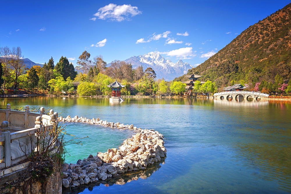 Heilongtan (Black Dragon Pool) with pool, pagodas, white marble bridge and mountain backdrop, Lijiang, Yunnan, China, Asia 