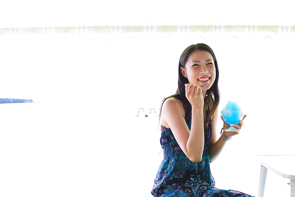 Portrait of a Japanese woman eating shaved ice