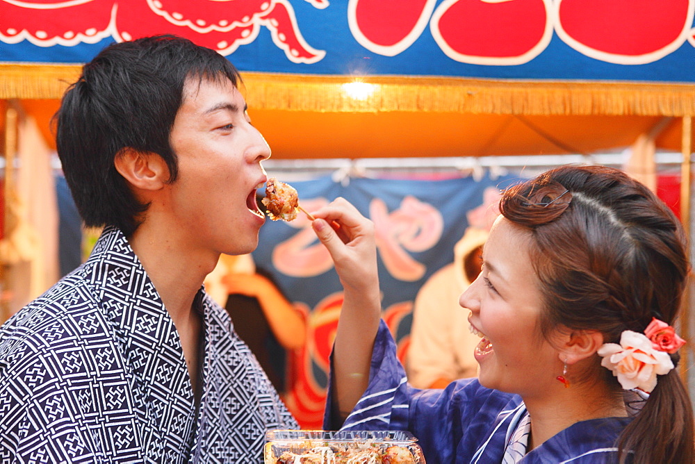 Young Japanese Couple Wearing Yukata at Summer Festival