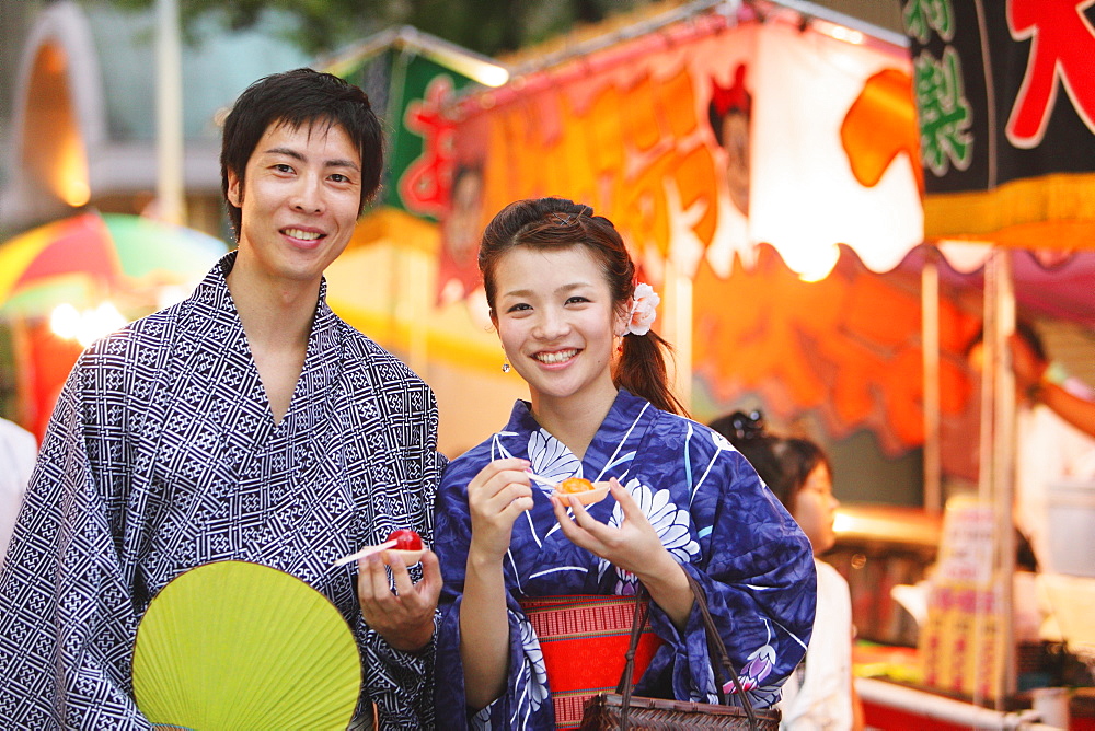 Young Japanese Couple Wearing Yukata at Summer Festival