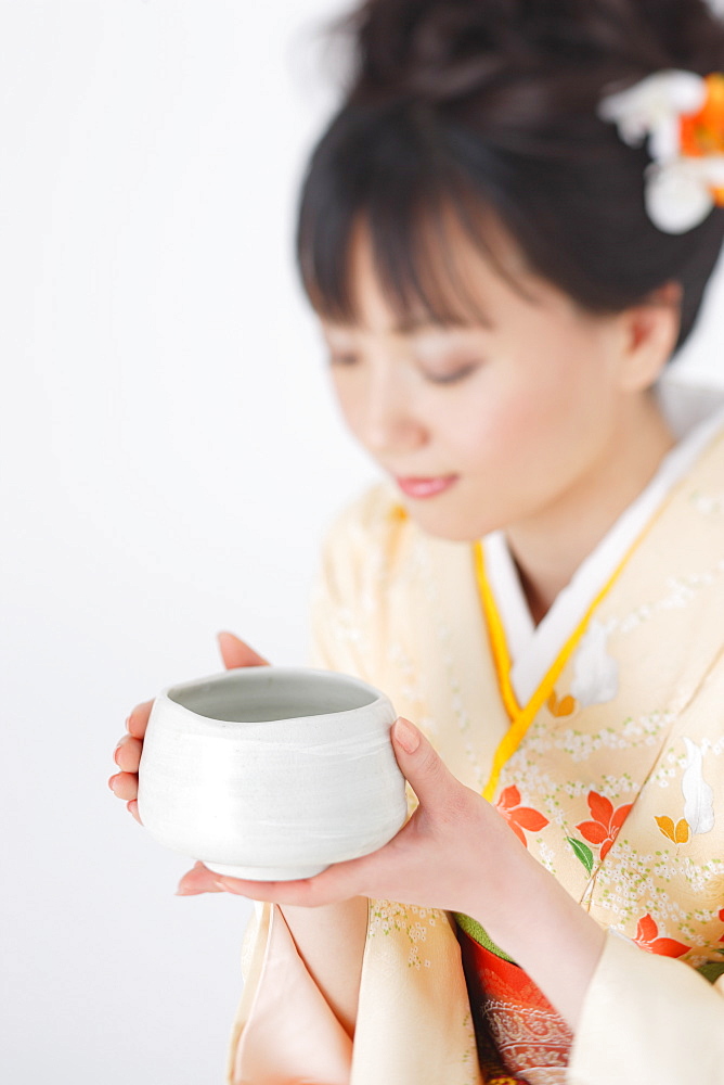 Japanese Woman Holding Bowl of Herbal Tea