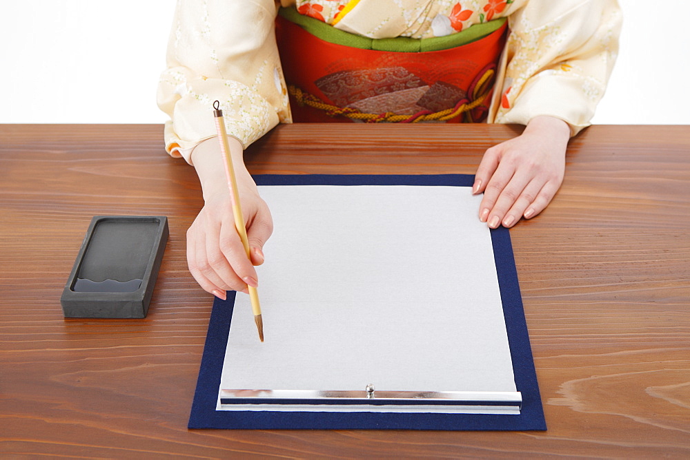 Woman Writing Calligraphy on Paper