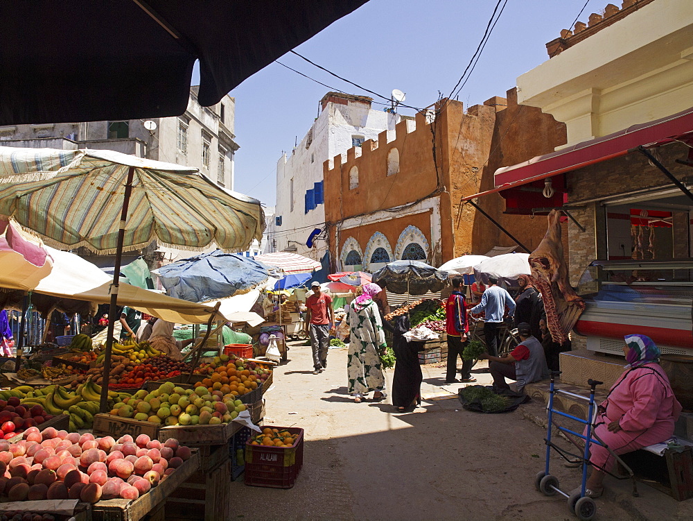 A market on the Socco Chico in the Medina of Larache, Morocco, with the good covered with a sunshade