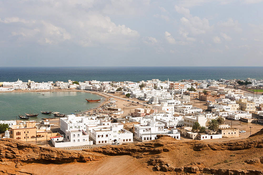 View of town with houses and harbour in Sur, Oman