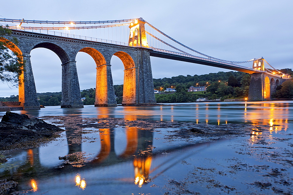 View of Illuminated Menai Bridge at dusk in Anglesey, Wales, UK