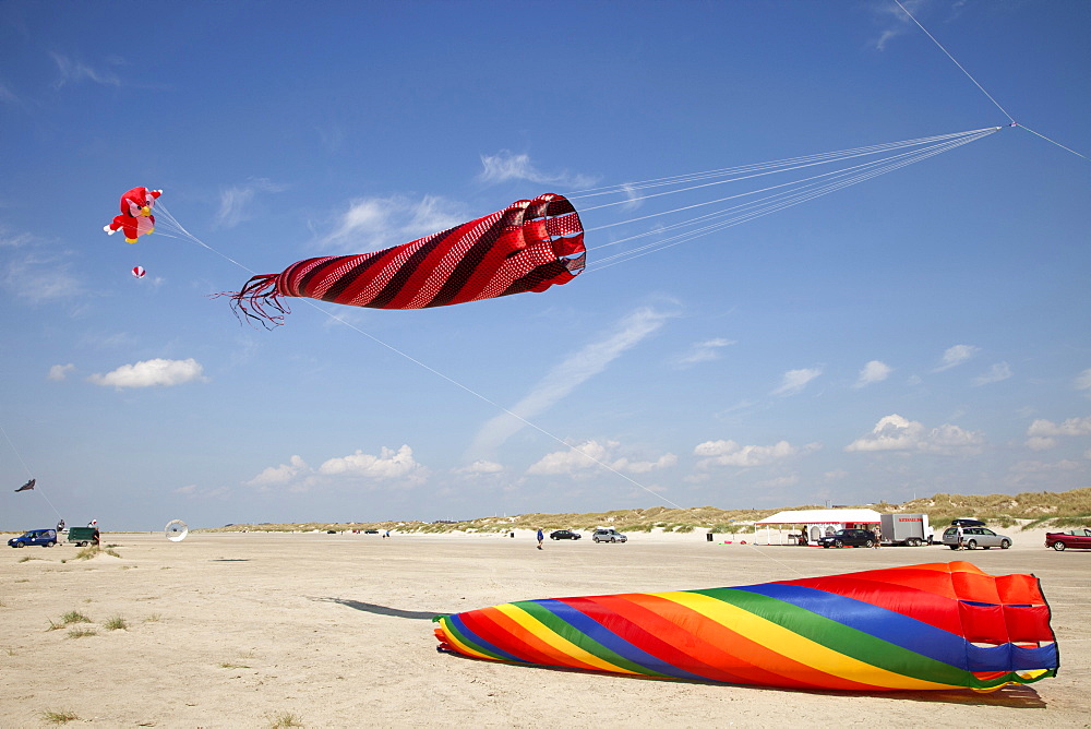 Multi-coloured flags in sky on kite festival at Fano beach, Denmark