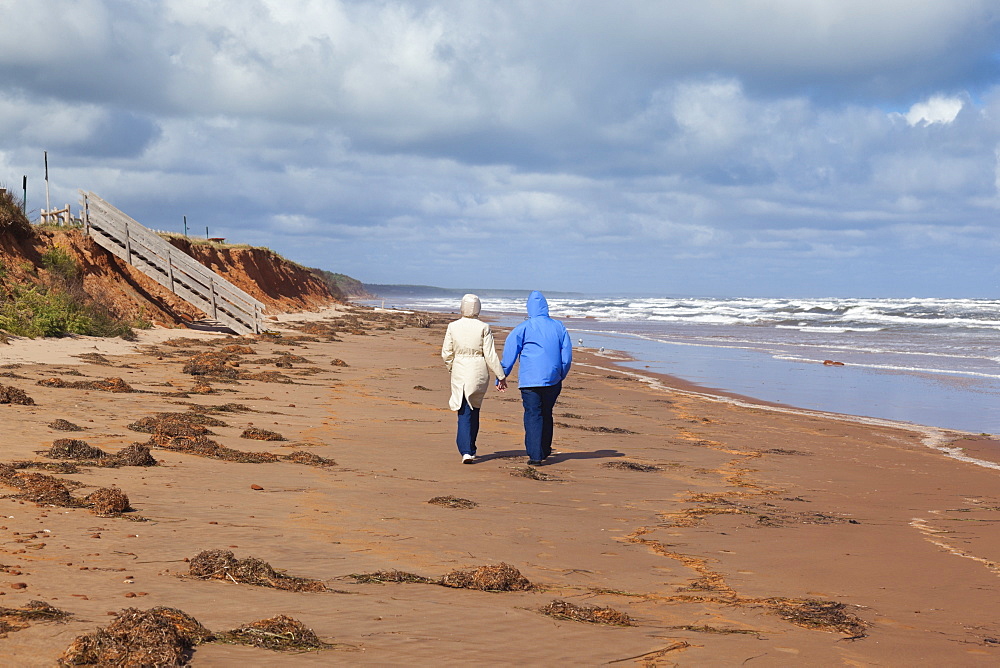 Couple walking on beach of Brackley-Dalvay, Prince Edward island National park, Canada