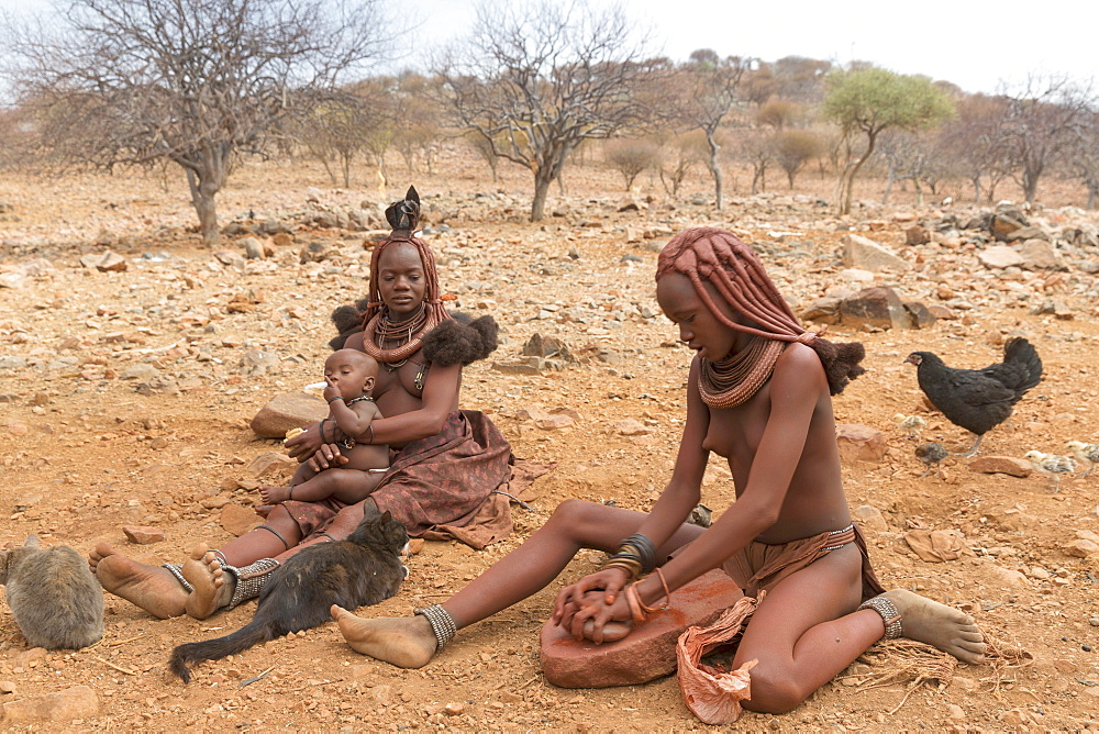 A mother and her children in a Himba village, indigenous tribe, Kunene, Namibia