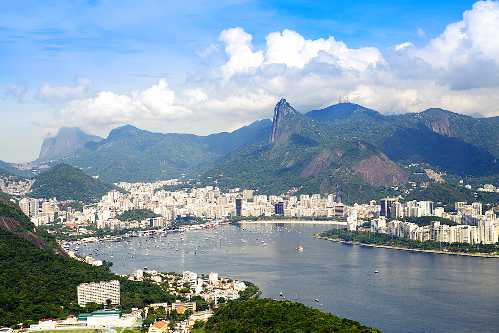 Aerial view of the city and Serra da Carioca mountains with Botafogo Bay, Corcovadao and the Christ in the foreground, Rio de Janeiro, Brazil, South America