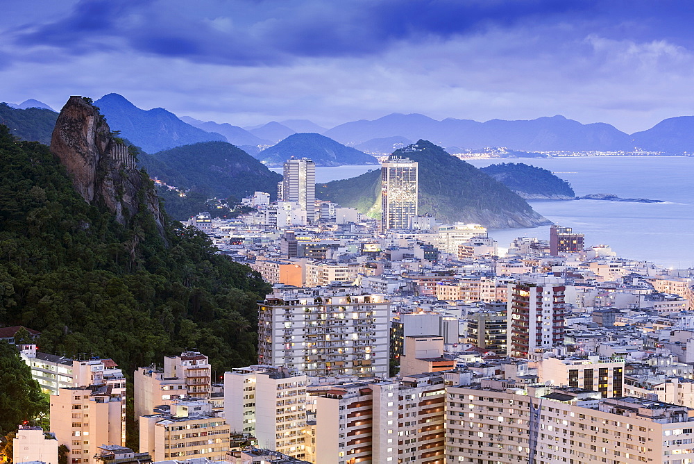 Twilight, illuminated view of Copacabana, the Morro de Sao Joao and the Atlantic coast of Rio, Rio de Janeiro, Brazil, South America