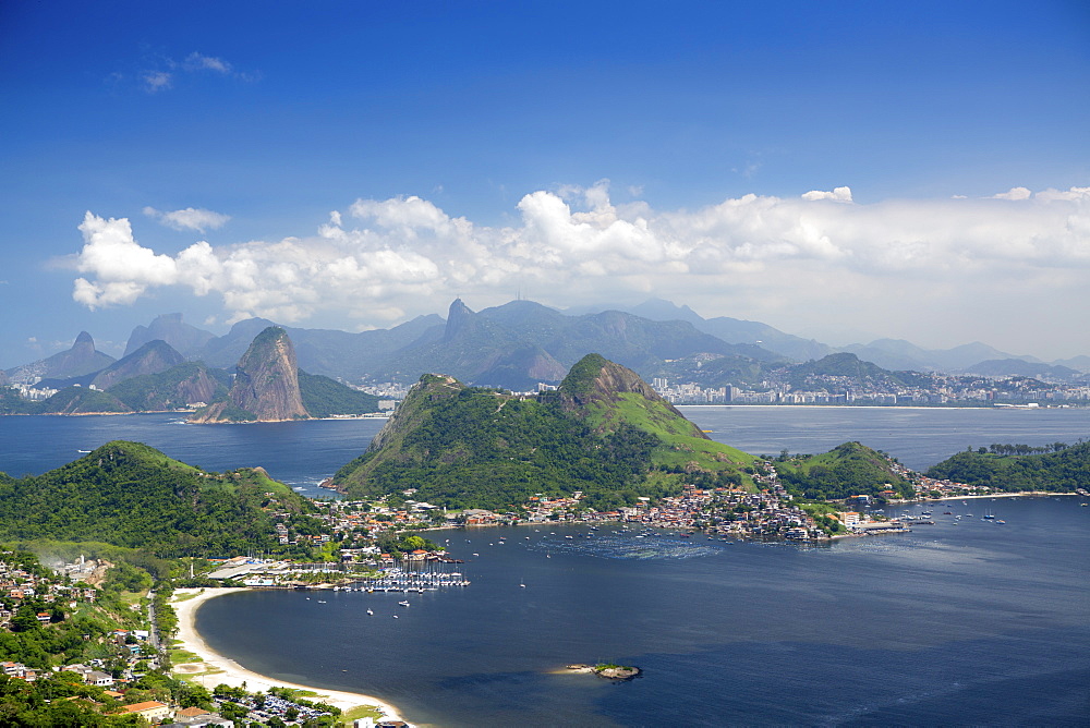 View of Rio, the Serra da Carioca mountains and Sugar Loaf with Charitas and Sao Francisco beaches in Niteroi in the foreground, Rio de Janeiro, Brazil, South America