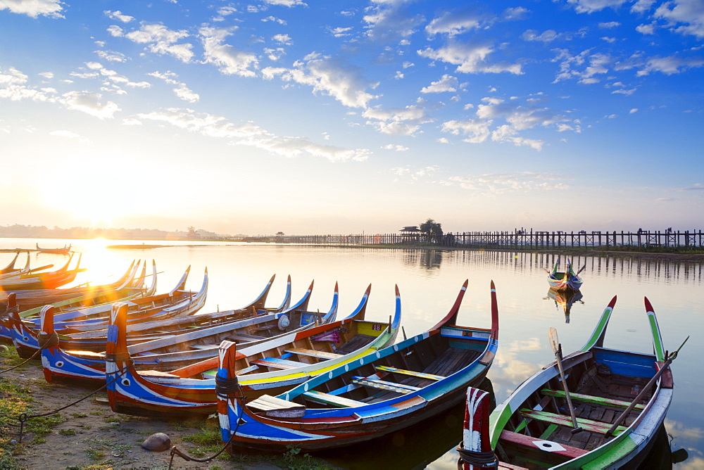 Boats on the Taungthaman Lake near Amarapura with the U Bein teak bridge behind, Mandalay, Myanmar (Burma), Southeast Asia